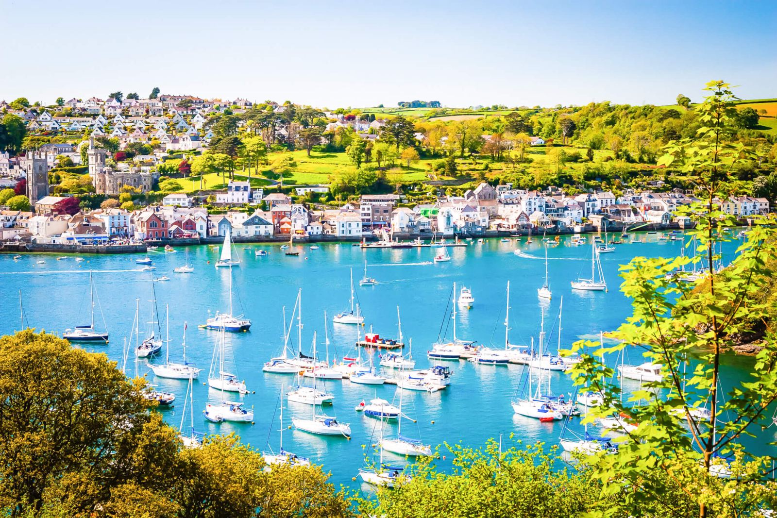 Fowey harbour full of sailing boats on a sunny day