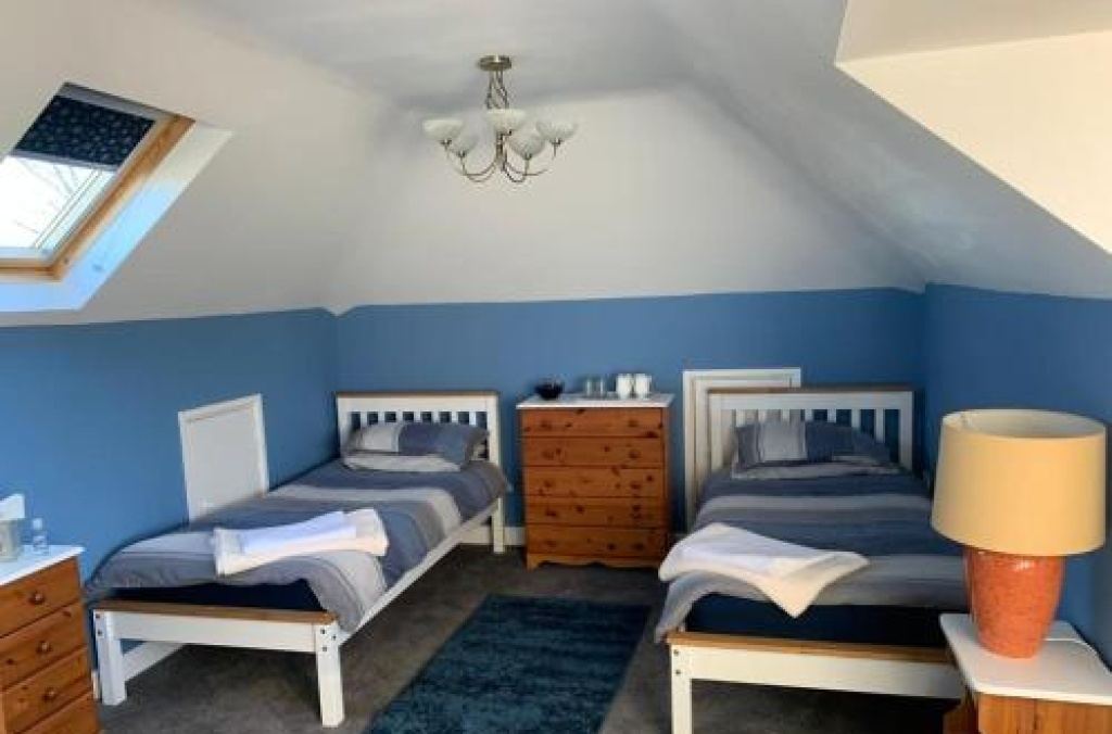 Attic twin bedroom with skylight