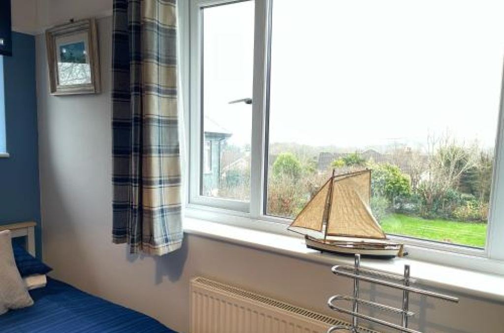 Bedroom window with model sailing boat on the sill